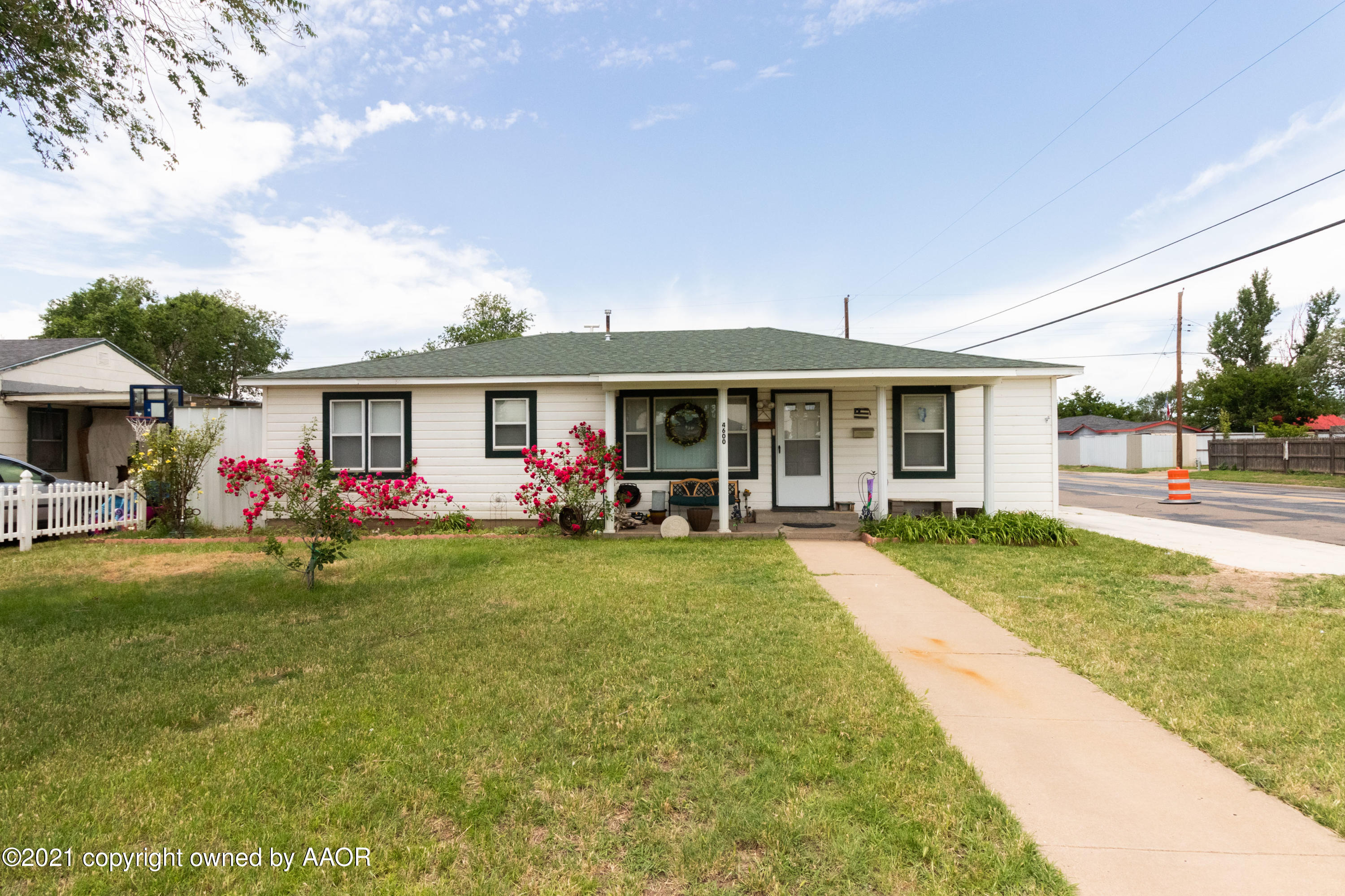 4600 Parker Street Amarillo, TX 79110 - Photo 1 of 28 a front view of a house with a porch and garden