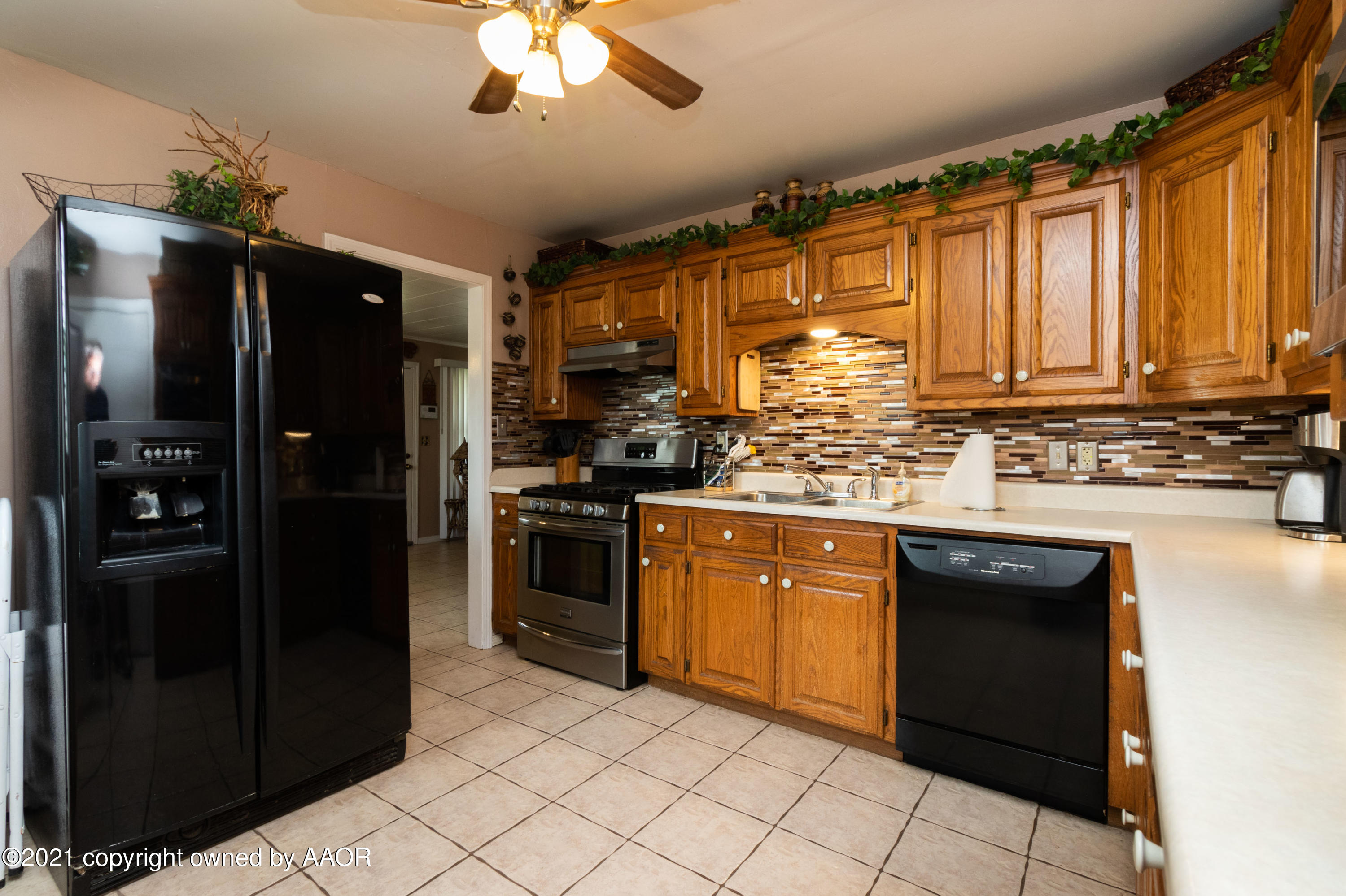 4600 Parker Street Amarillo, TX 79110 - Photo 12 of 28 a kitchen with stainless steel appliances granite countertop a refrigerator and a sink