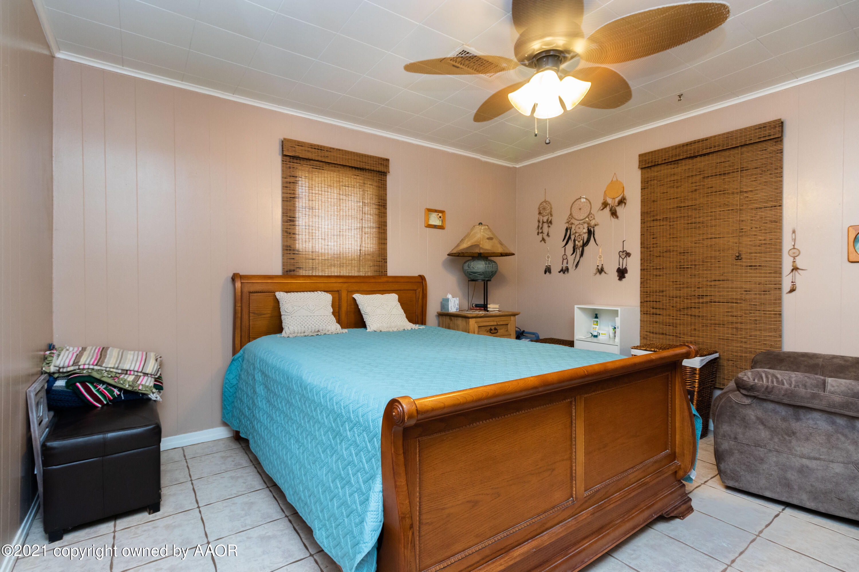 4600 Parker Street Amarillo, TX 79110 - Photo 17 of 28 a bed room with a bed and a chandelier