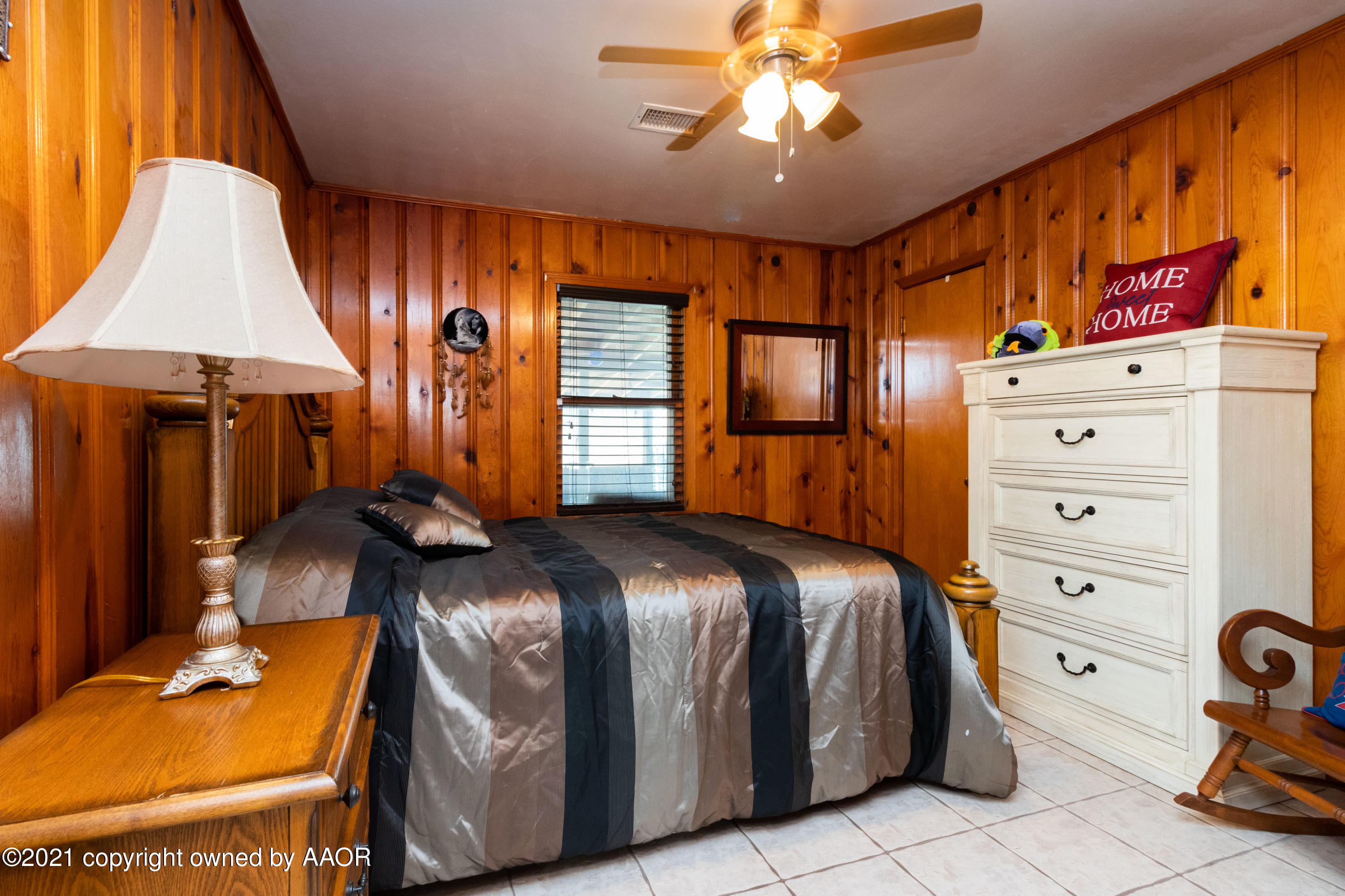 4600 Parker Street Amarillo, TX 79110 - Photo 19 of 28 a bedroom with a bed and a chandelier