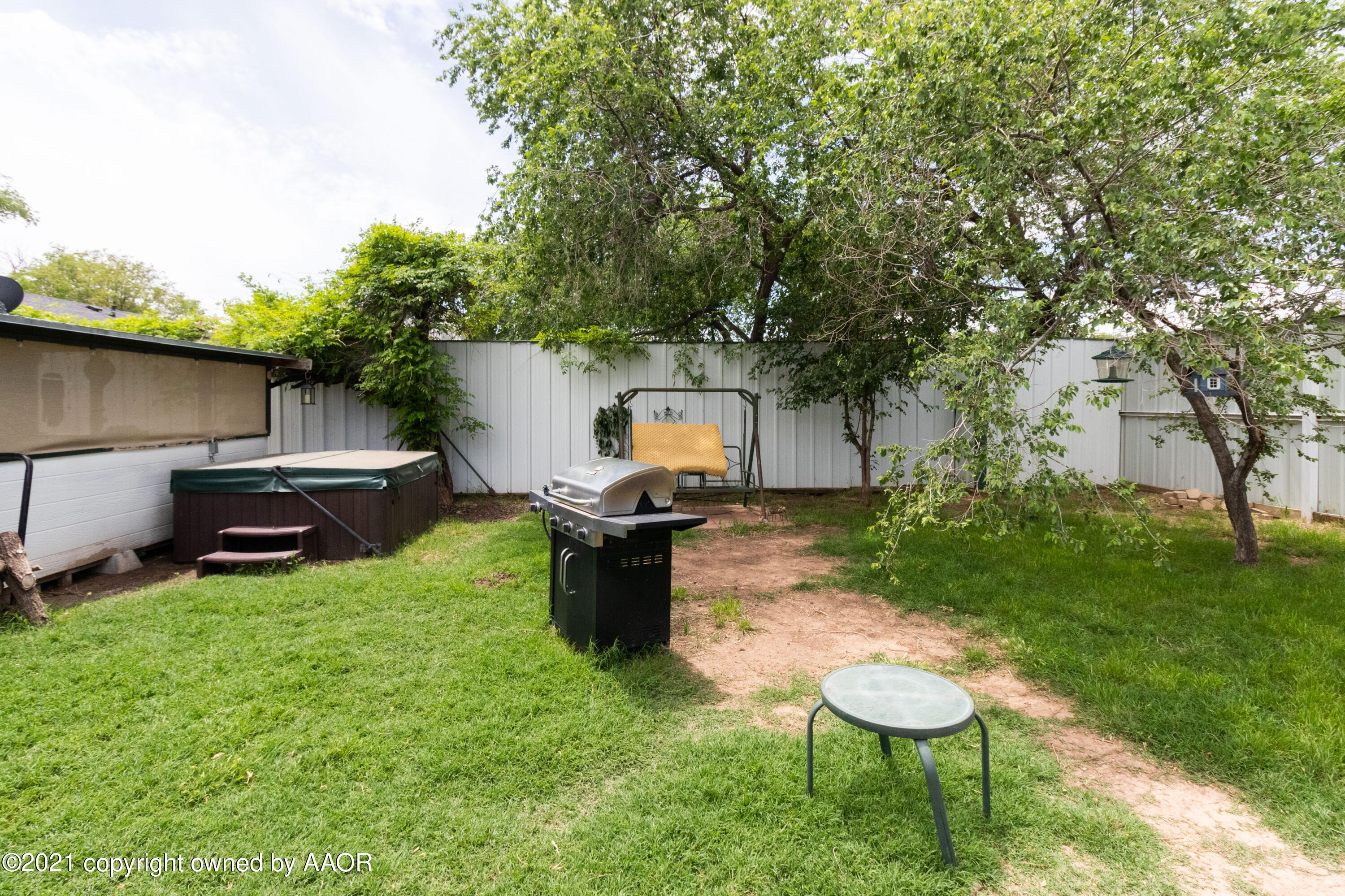 4600 Parker Street Amarillo, TX 79110 - Photo 25 of 28 a view of a backyard with table and chairs a barbeque and a large trees