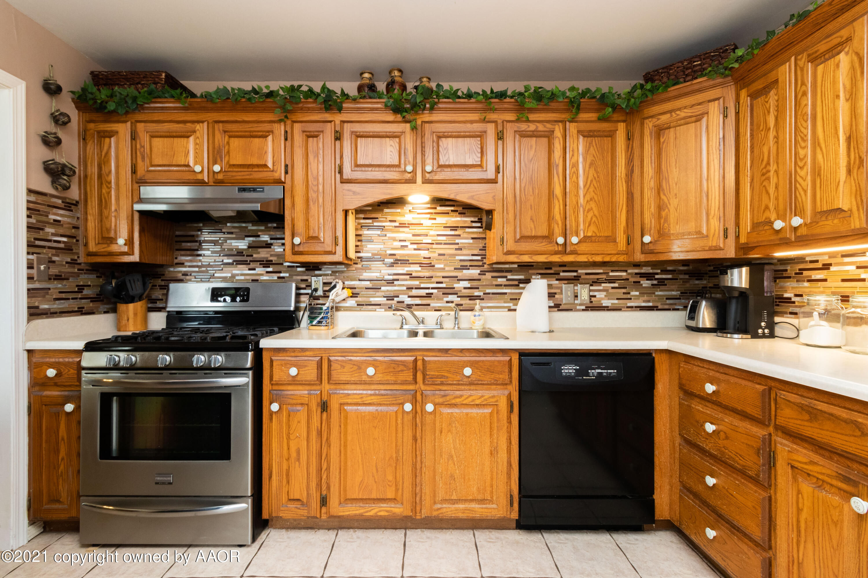 4600 Parker Street Amarillo, TX 79110 - Photo 10 of 28 a kitchen with stainless steel appliances granite countertop a stove a sink and a microwave