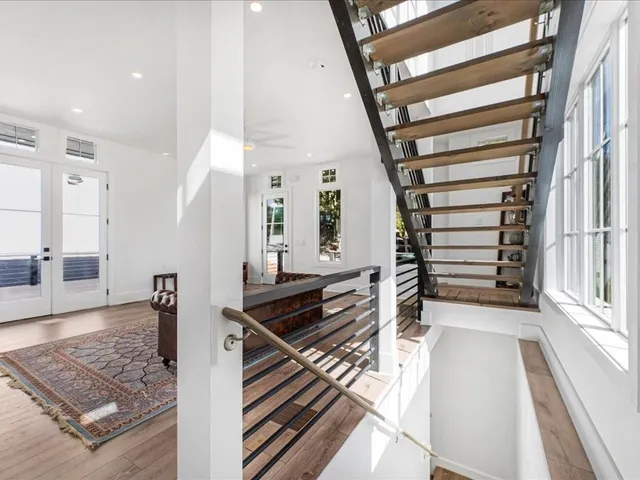 a view of an entryway with wooden floor and a living room