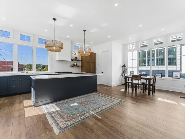a kitchen with a table chairs sink and cabinets