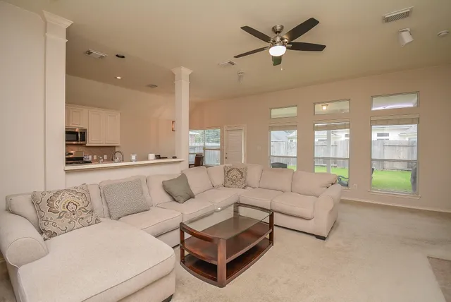 a kitchen with stainless steel appliances a stove a sink a microwave a refrigerator and cabinets