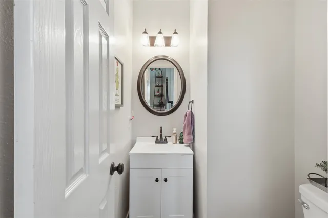 a bathroom with a sink a mirror and a toilet