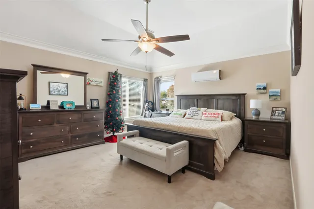 a spacious bedroom with a bed and a mirror on the dresser