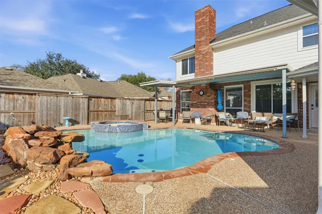 a view of a house with swimming pool and furniture