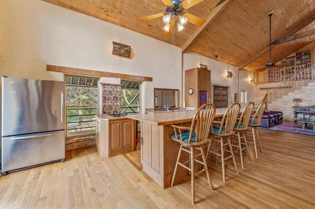 a dining room with furniture window wooden floor and chandelier