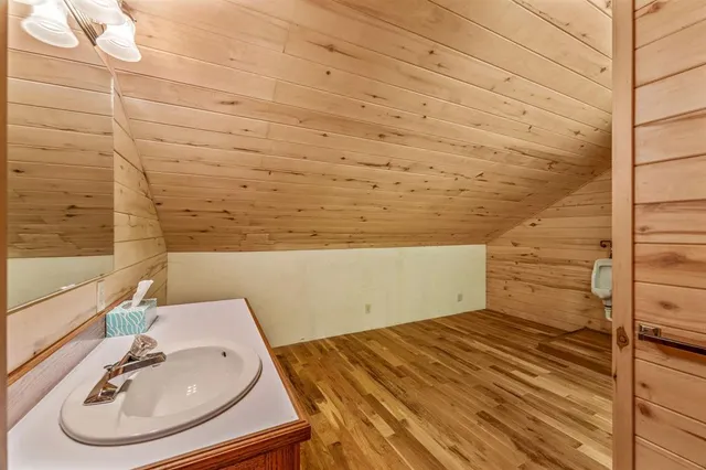 a room with stainless steel appliances kitchen island granite countertop furniture and a shower