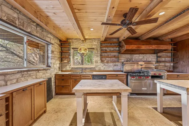 an empty room with fireplace and chandelier