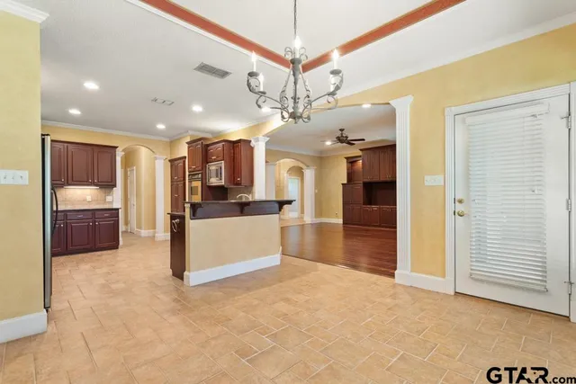 a view of a kitchen with a sink and a refrigerator