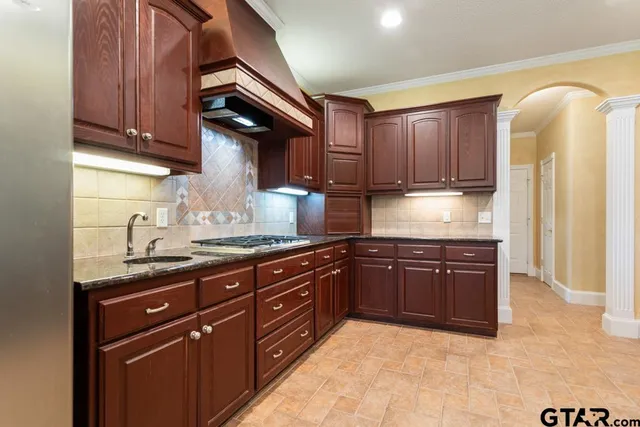 a kitchen with granite countertop wooden cabinets and a granite counter top