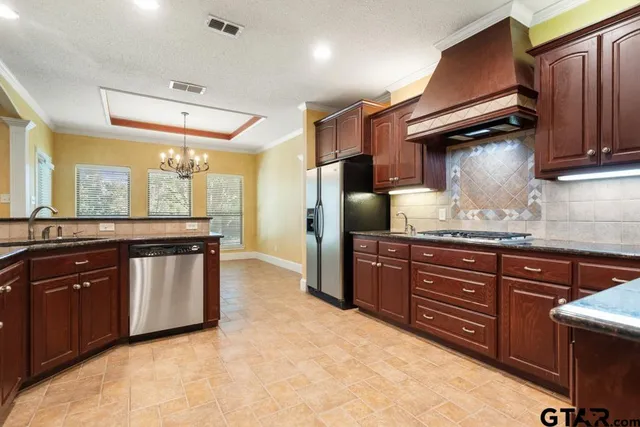 a kitchen with a sink refrigerator and cabinets