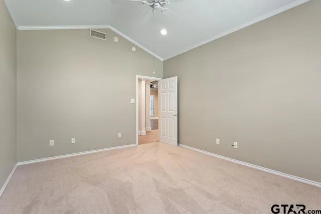 an empty room with wooden floor and a ceiling fan