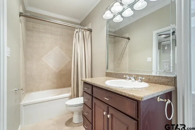 a view of an empty room with a window and cabinet