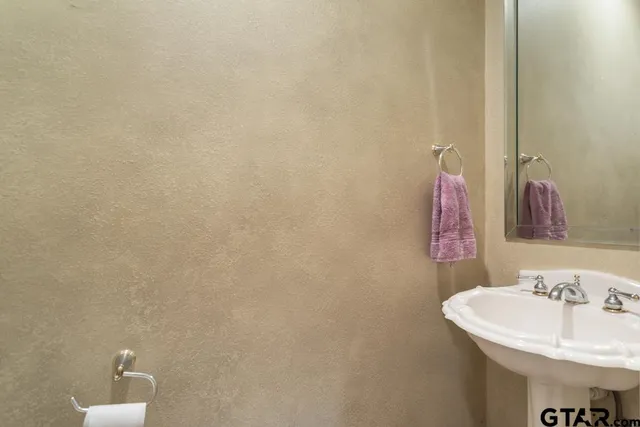 a bathroom with a sink and cabinets