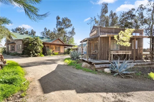 a view of a house with backyard and sitting area