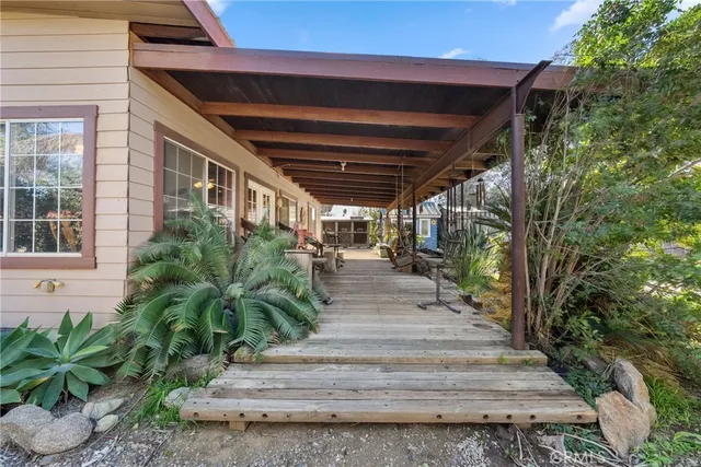 a view of a porch with wooden floor and furniture