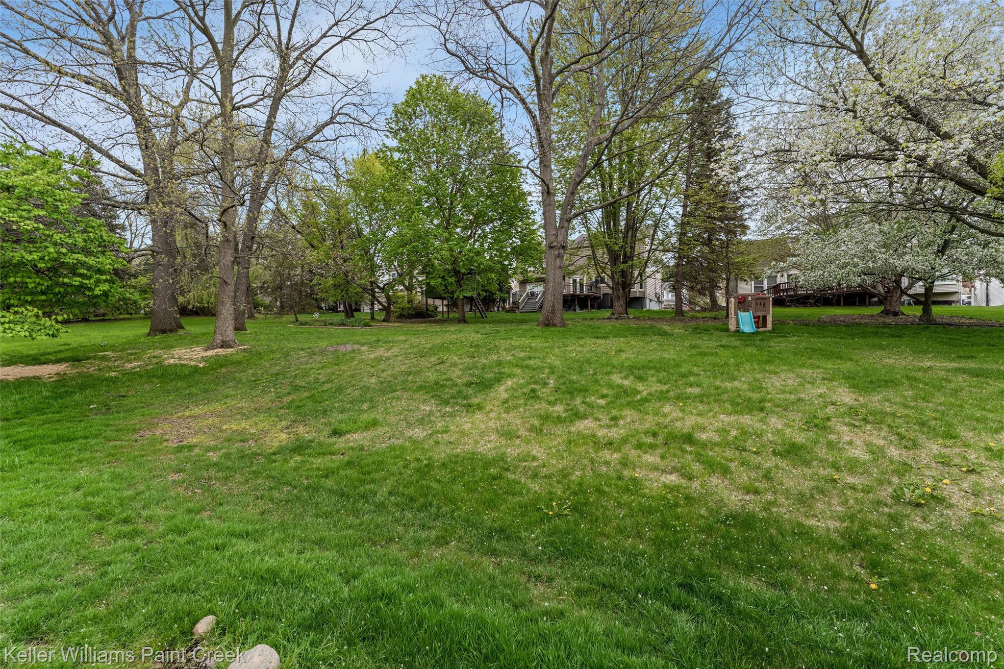 366 Whitney Drive Rochester, MI 48307 - Photo 34 of 44 View of green lawn with view of scattered trees