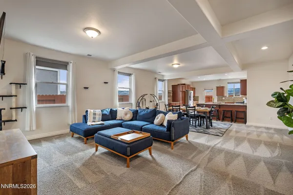a living room with furniture a table and a potted plant
