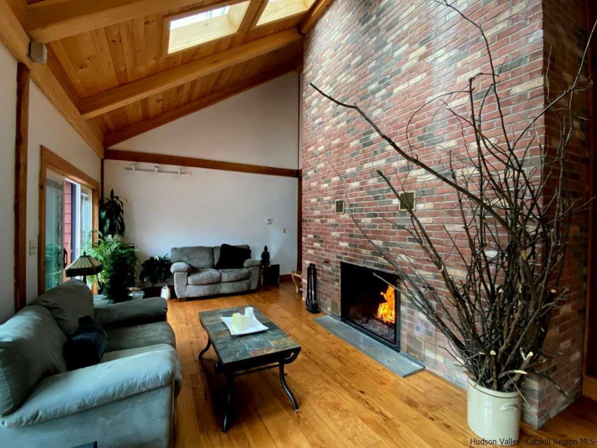 56 Ridge Road Shokan, NY 12481 - Photo 15 of 34 a backyard of a house with fireplace table and sofas