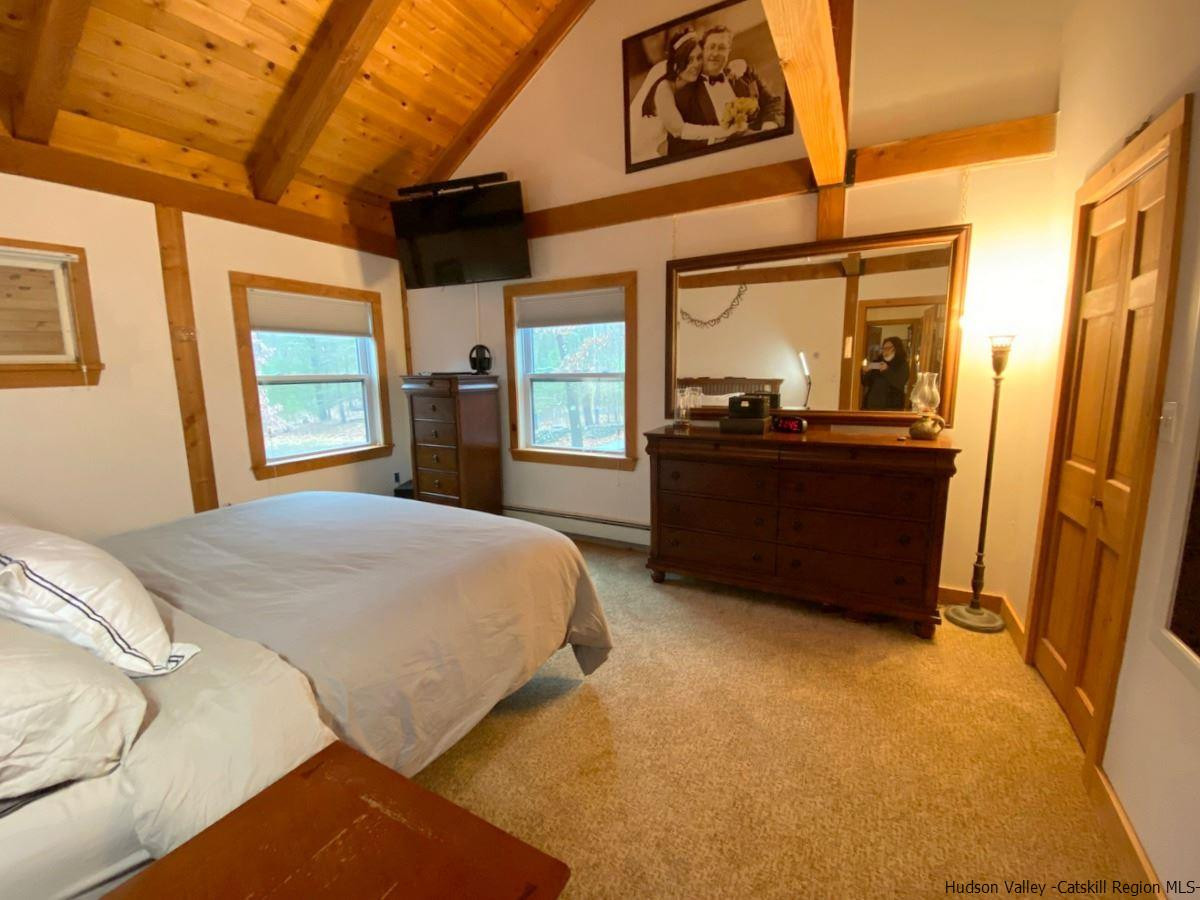 56 Ridge Road Shokan, NY 12481 - Photo 23 of 34 a bedroom with a bed dresser and a large window
