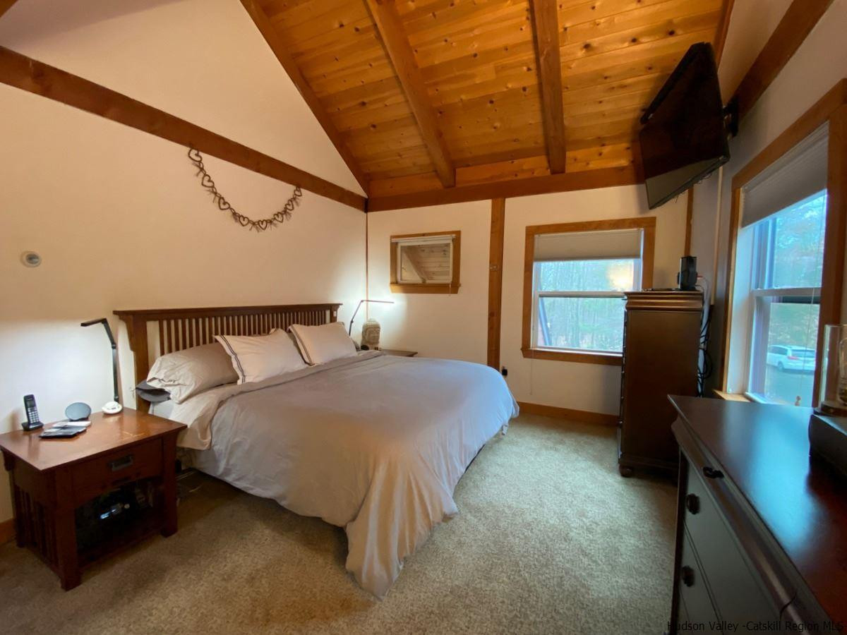 56 Ridge Road Shokan, NY 12481 - Photo 24 of 34 a bedroom with a bed and a dresser next to a window