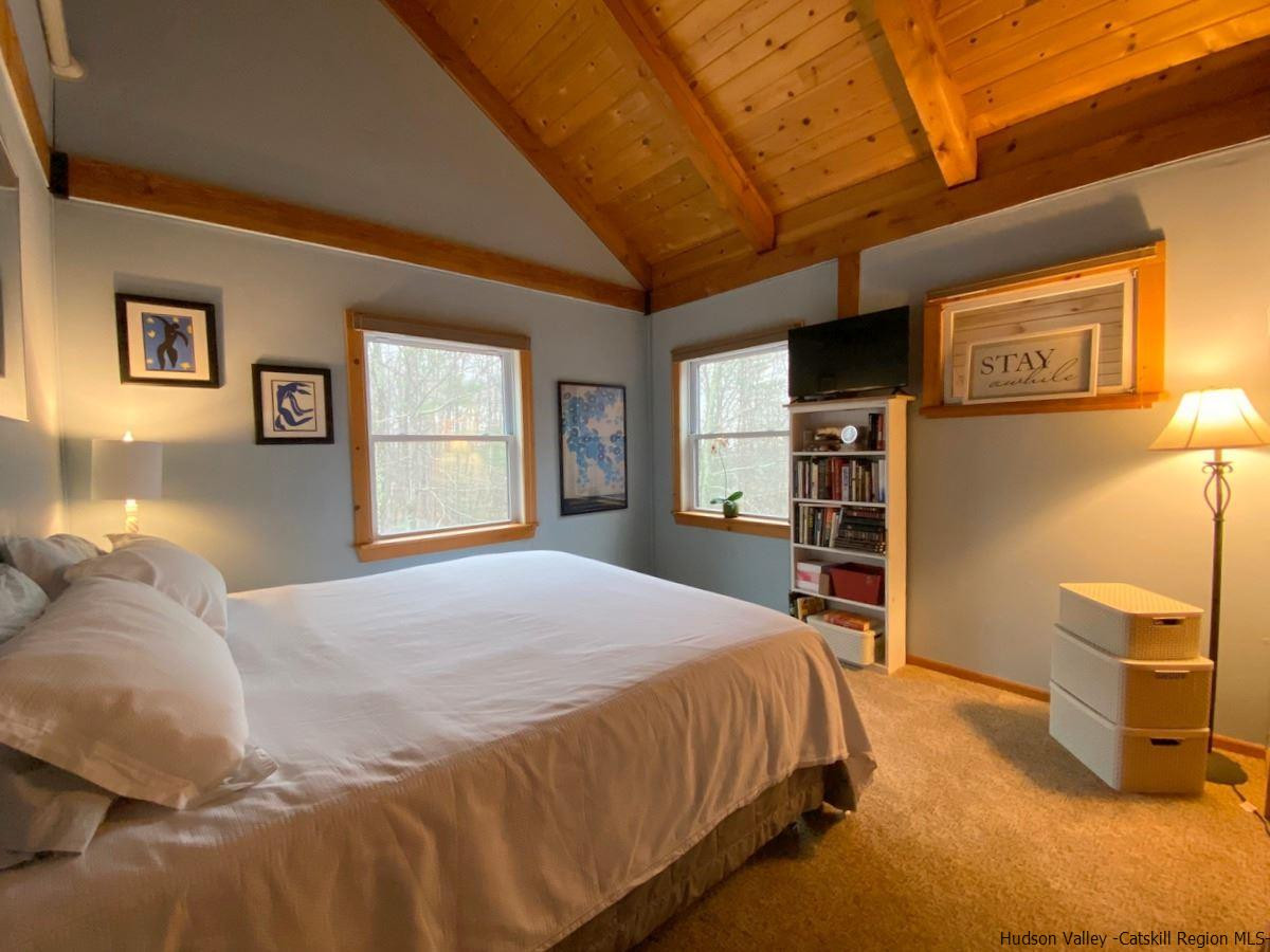 56 Ridge Road Shokan, NY 12481 - Photo 27 of 34 a bed sitting in a bedroom next to a window