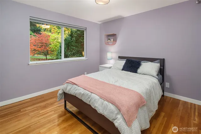 a bed sitting in a bedroom next to a window