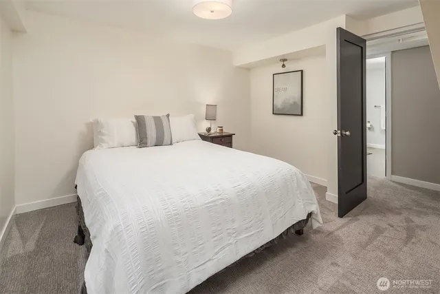 a large bed sitting in a bedroom and a table