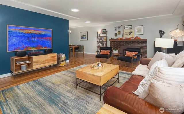 a living room with furniture a flat screen tv and a fireplace