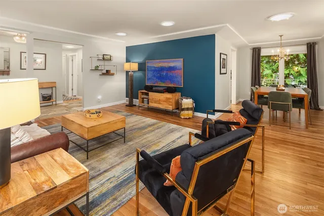 a living room with furniture a flat screen tv and a large window