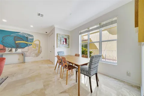 a large kitchen with stainless steel appliances granite countertop a sink and a refrigerator