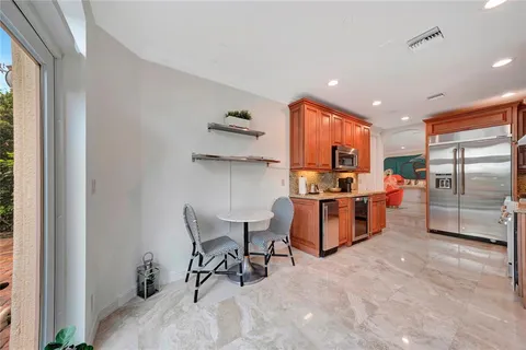 a view of a dining room with furniture a chandelier and wooden floor