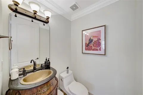 a spacious bathroom with a granite countertop sink a toilet and a bathtub