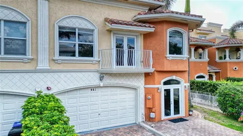 a front view of a house with plants