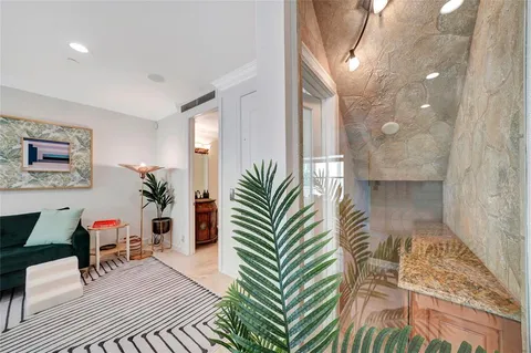 a living room with furniture a fireplace and a chandelier