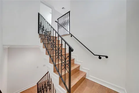 a bathroom with a granite countertop toilet a sink and a mirror