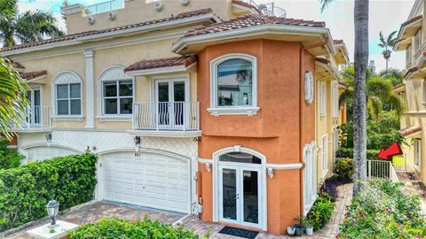 a front view of a house with plants
