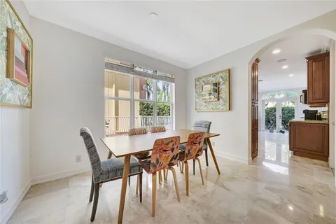 a view of a dining room with furniture and a floor to ceiling window
