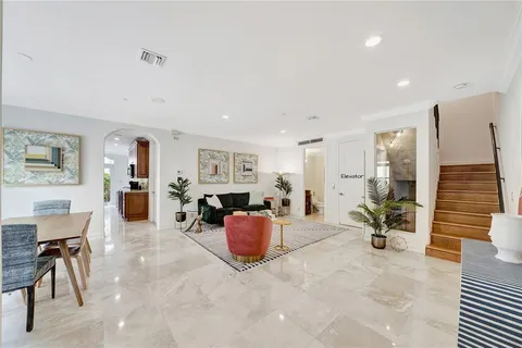 a open kitchen with stainless steel appliances granite countertop a refrigerator and a stove top oven