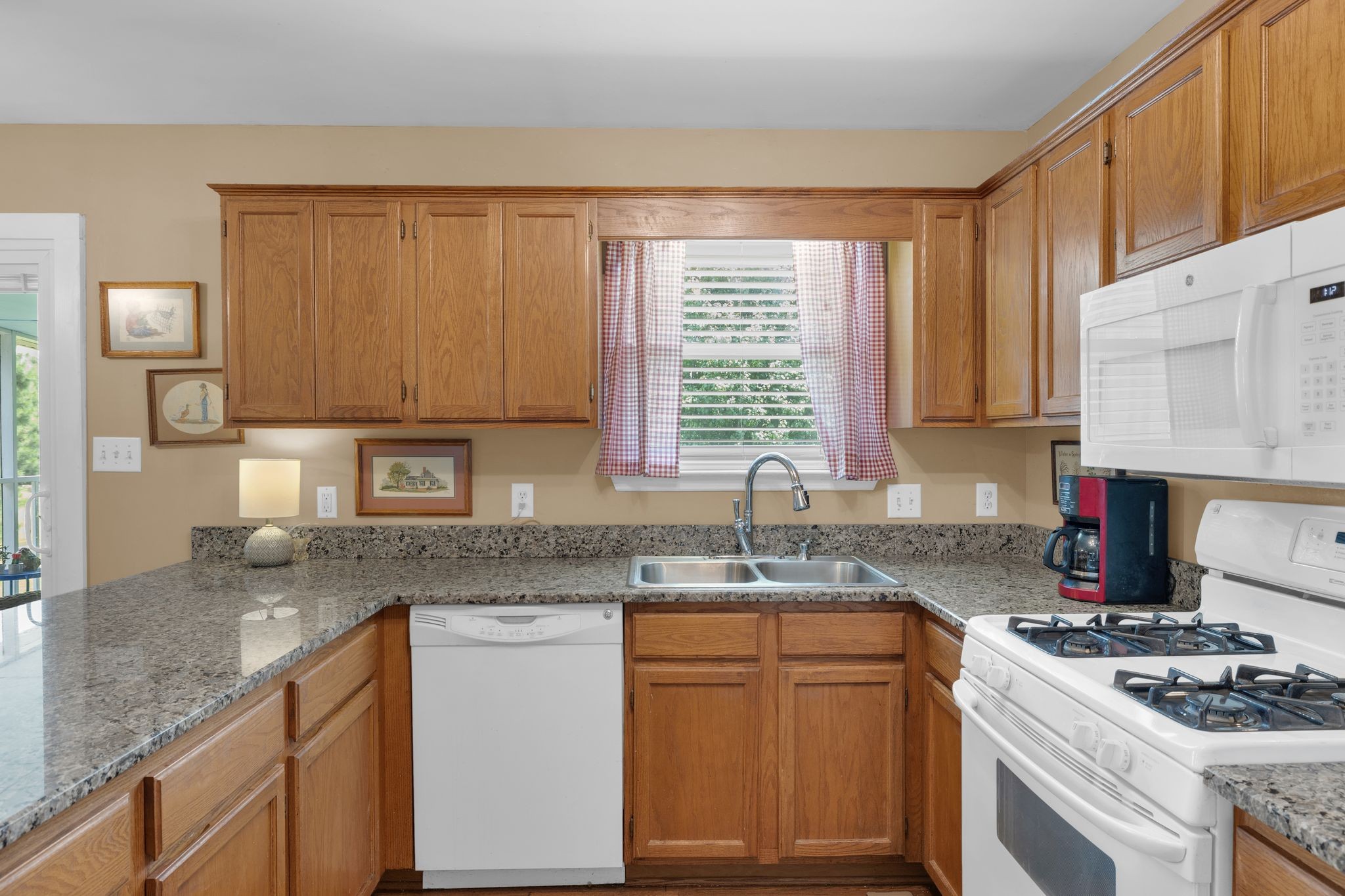 2113 Spring Lake Drive Spring Hill, TN 37174 - Photo 11 of 27 a kitchen with stainless steel appliances granite countertop a sink stove cabinets and a counter top space