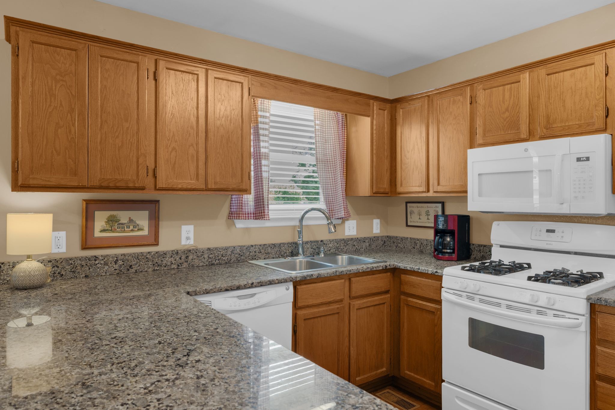 2113 Spring Lake Drive Spring Hill, TN 37174 - Photo 12 of 27 a kitchen with stainless steel appliances granite countertop a sink stove and cabinets