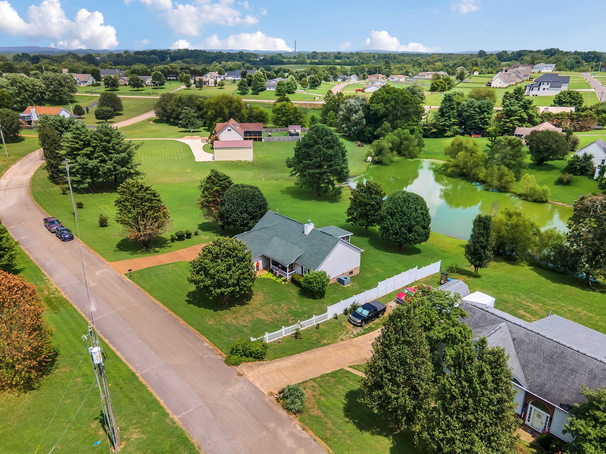 2113 Spring Lake Drive Spring Hill, TN 37174 - Photo 27 of 27 an aerial view of green landscape with trees houses and mountain view