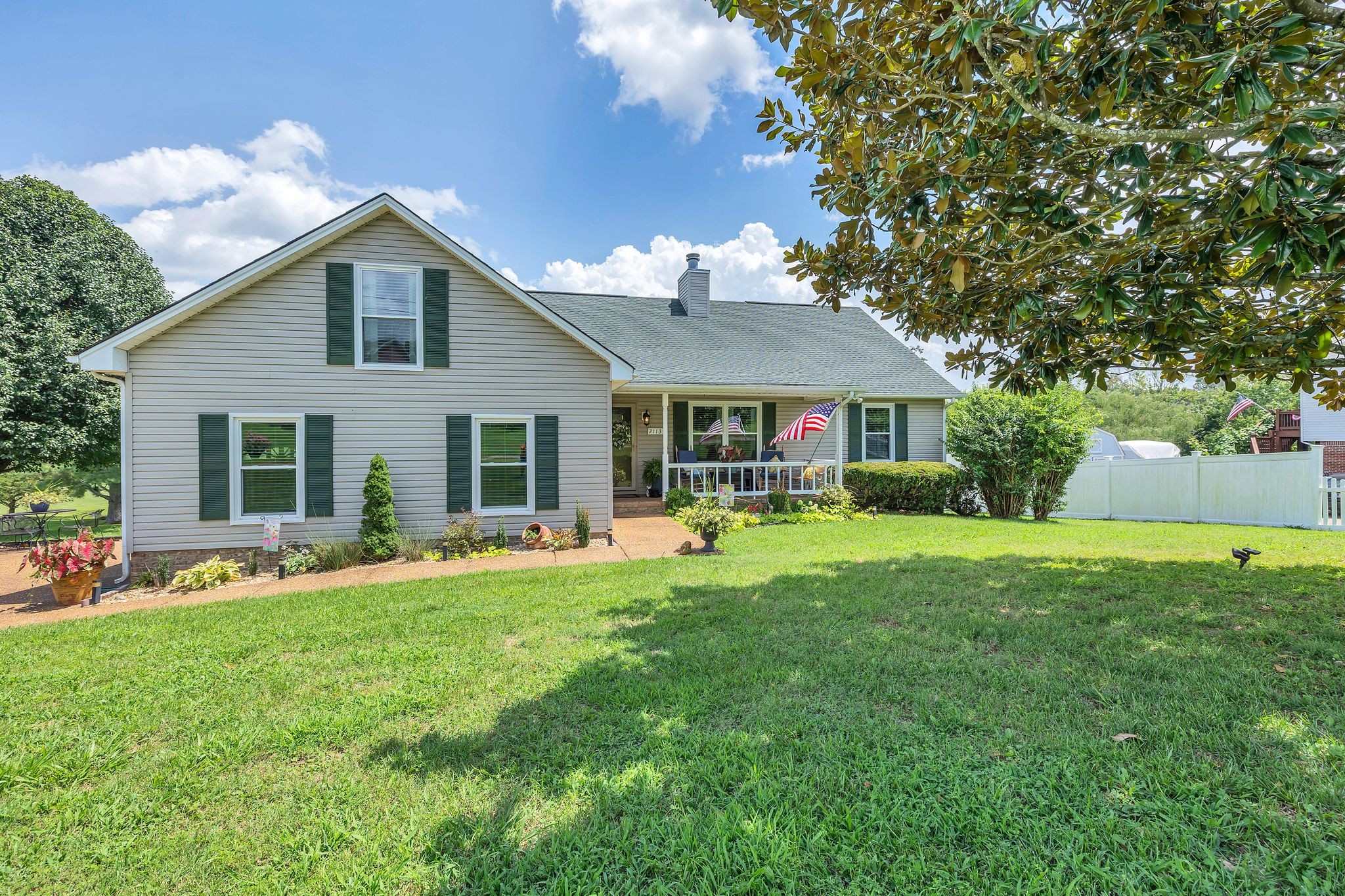 2113 Spring Lake Drive Spring Hill, TN 37174 - Photo 4 of 27 a front view of a house with a garden and porch