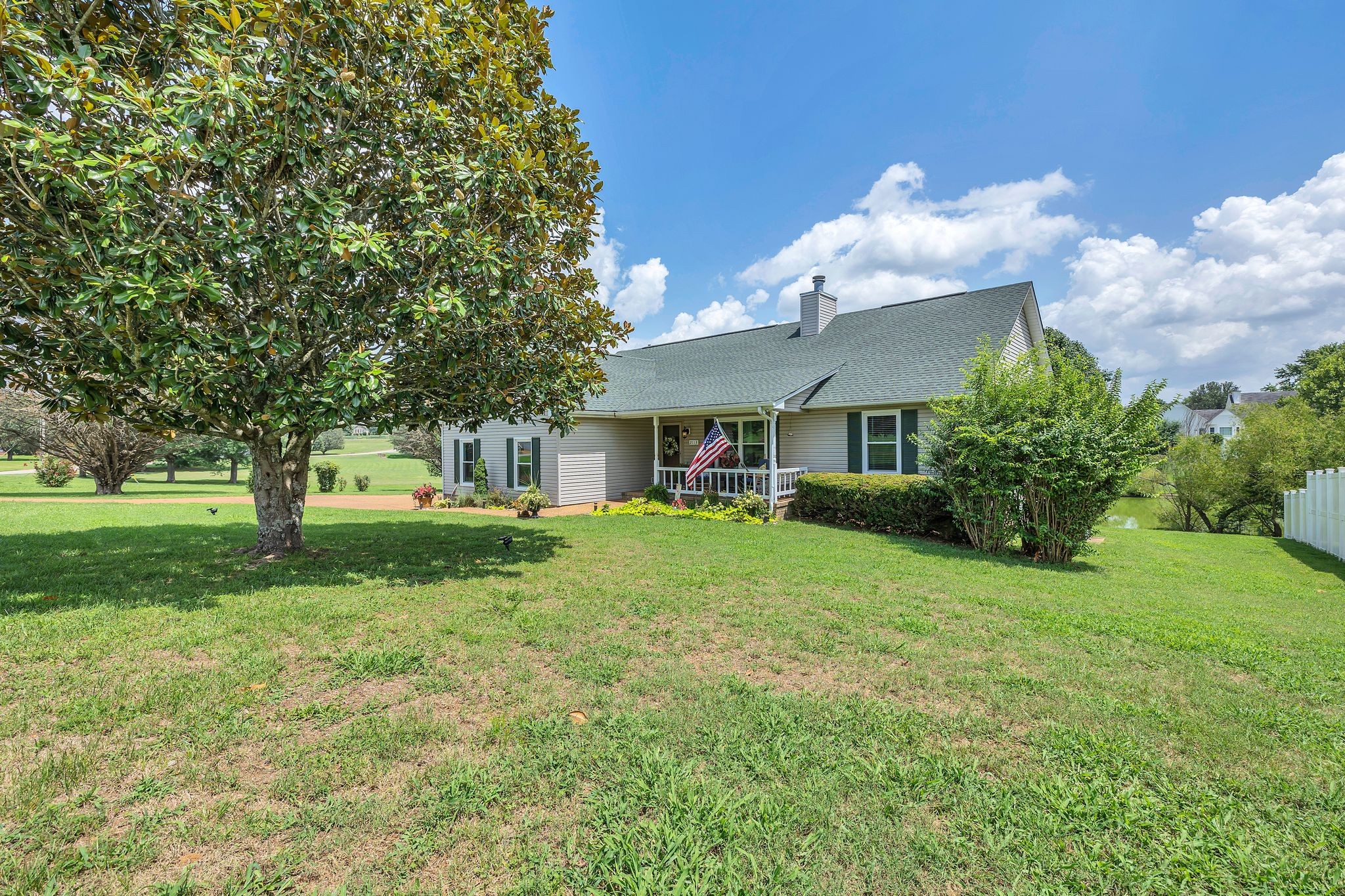 2113 Spring Lake Drive Spring Hill, TN 37174 - Photo 5 of 27 a front view of a house with garden and trees