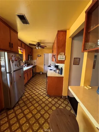 a kitchen with stainless steel appliances a refrigerator and a stove