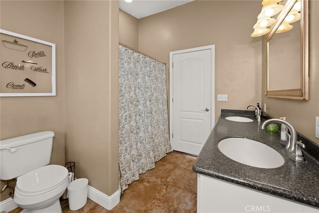 2728 Pentz Road Oroville, CA 95965 - Photo 22 of 52 a bathroom with a granite countertop sink and a mirror