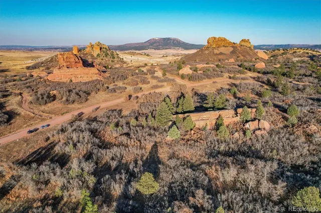 a view of a large building with mountains in the background